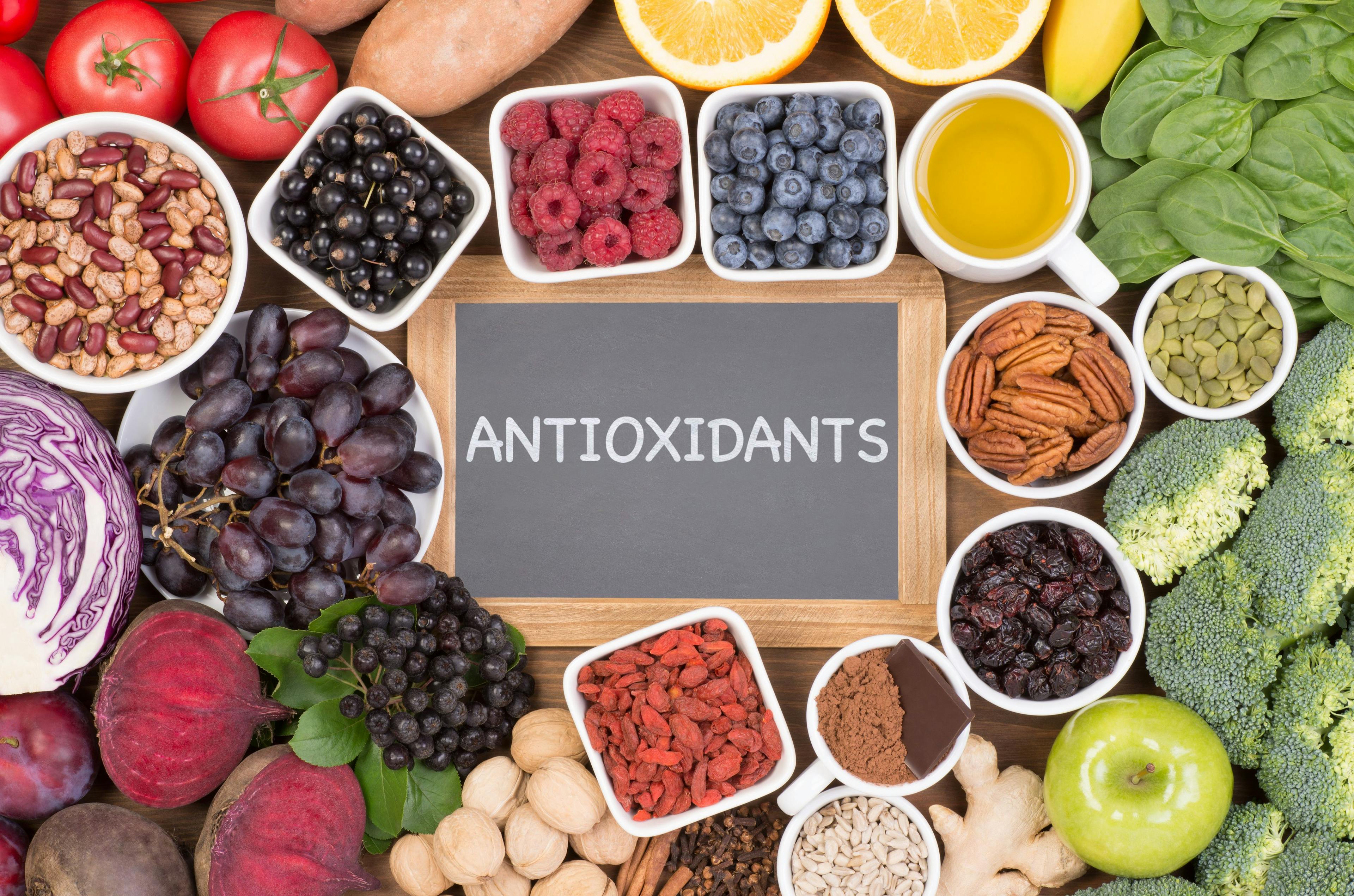 "antioxidants" written on blackboard surrounded by natural antioxidant sources | Image Credit: photka - stock.adobe.com 