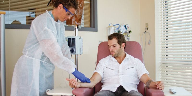 man receiving chemotherapy from a doctor