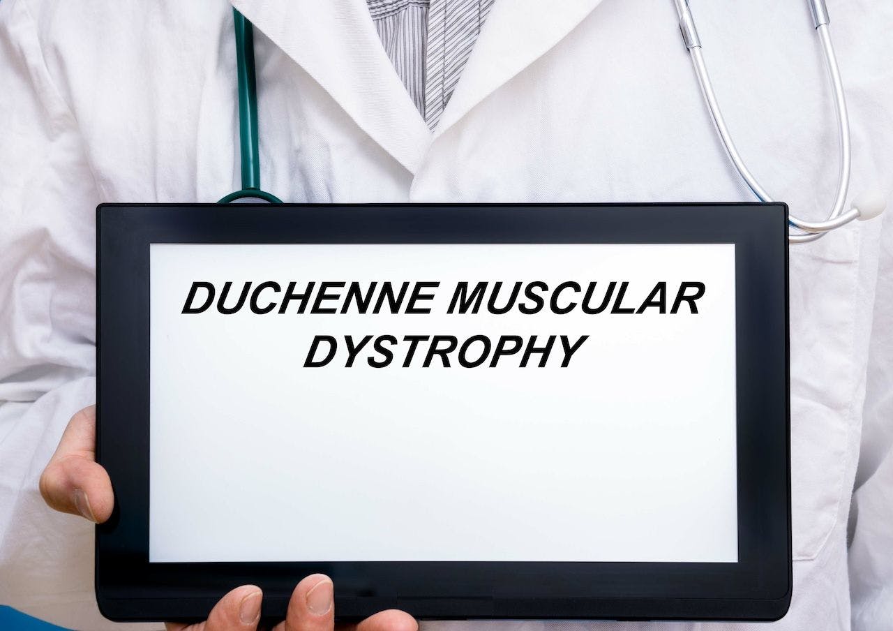 Doctor holding tablet reading Duchenne muscular dystrophy | Image credit: luchschenF - stock.adobe.com