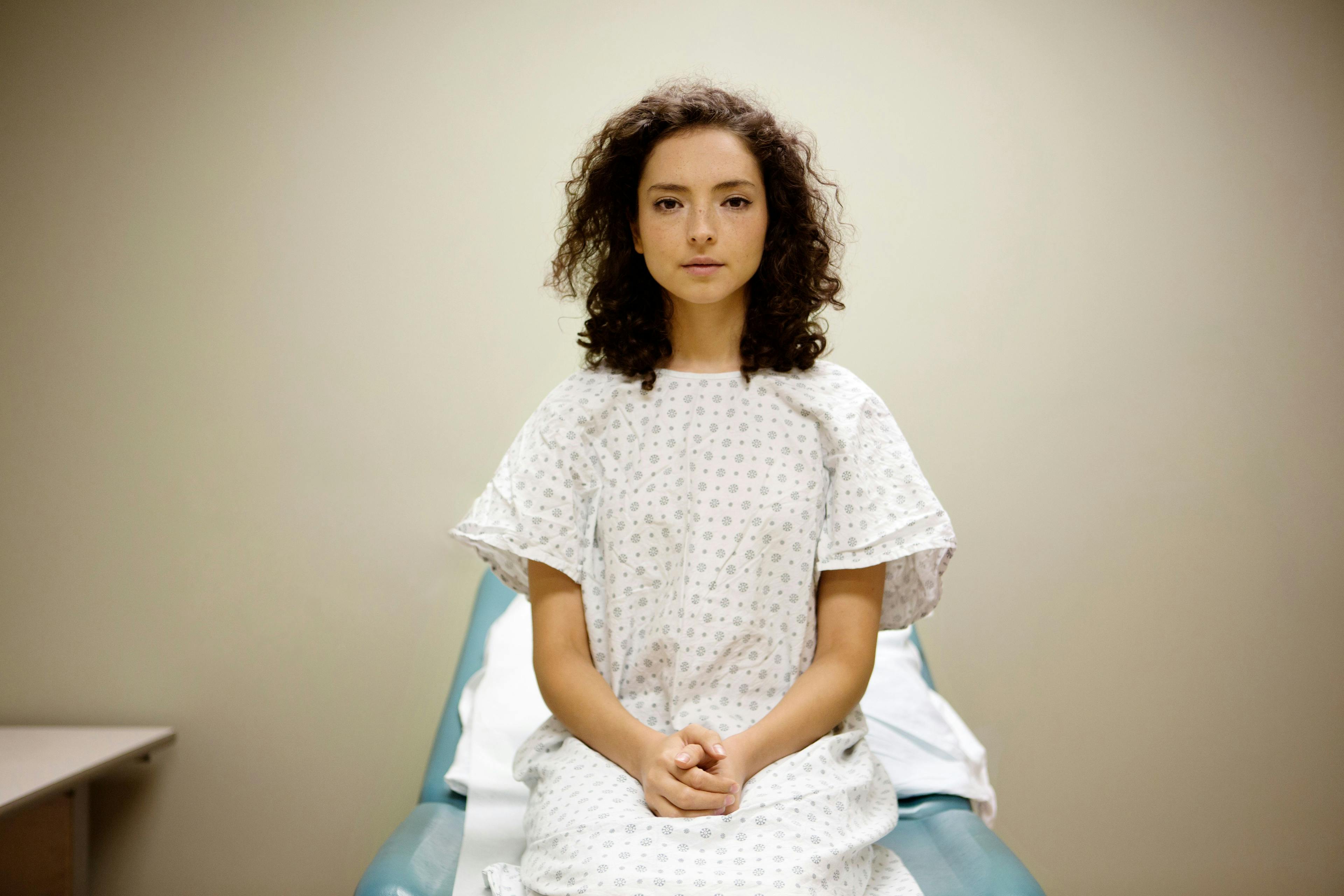 Portrait of patient sitting on hospital bed - Cavan for Adobe - stock.adobe.com