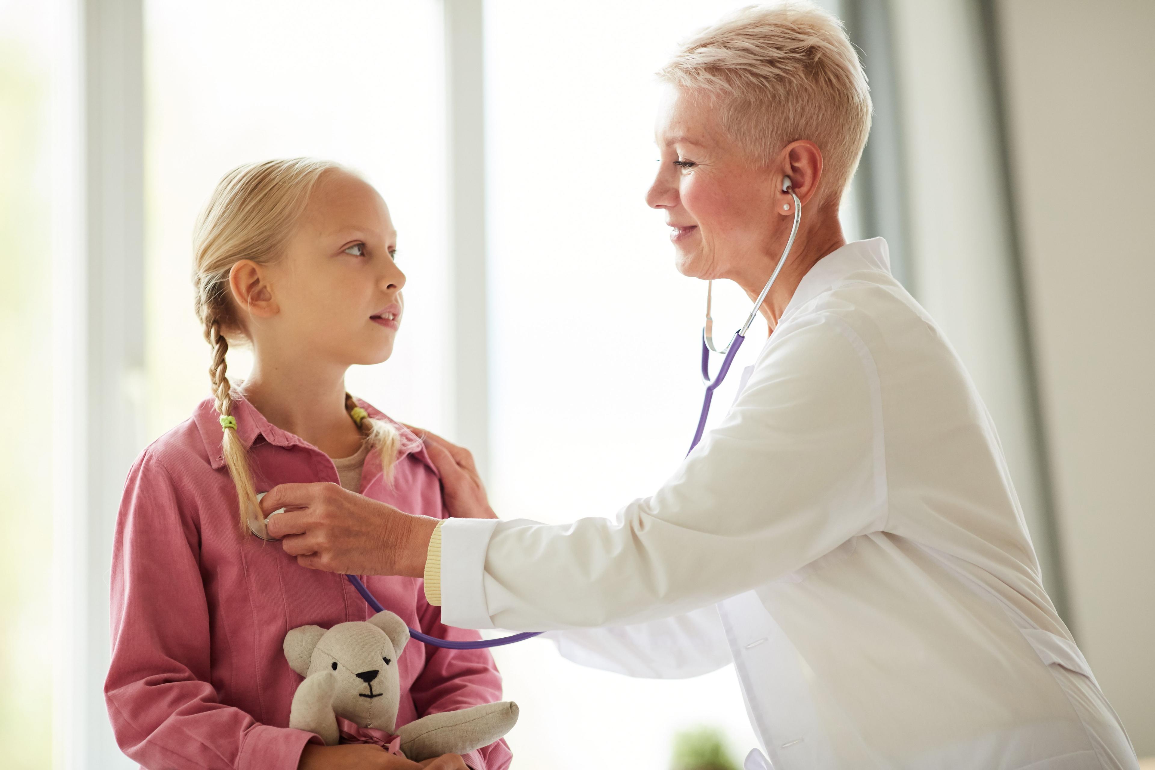 Pediatrician using stethoscope to listen to girl's breathing | Image credit: Mediaphotos – stock.adobe.com