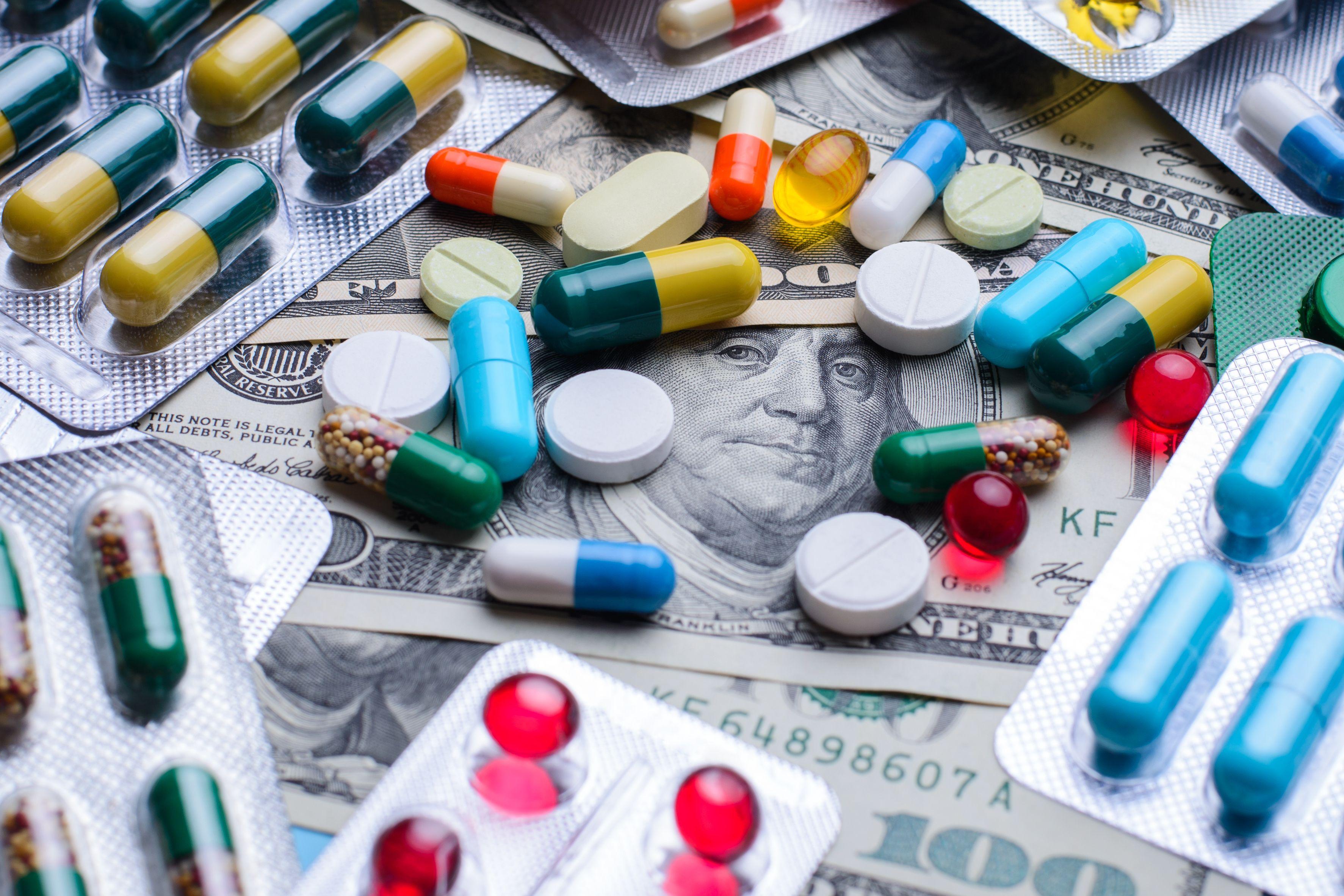 Prescription drugs on a money banknotes. Concept of healthcare costs - Vitalii - stock.adobe.com