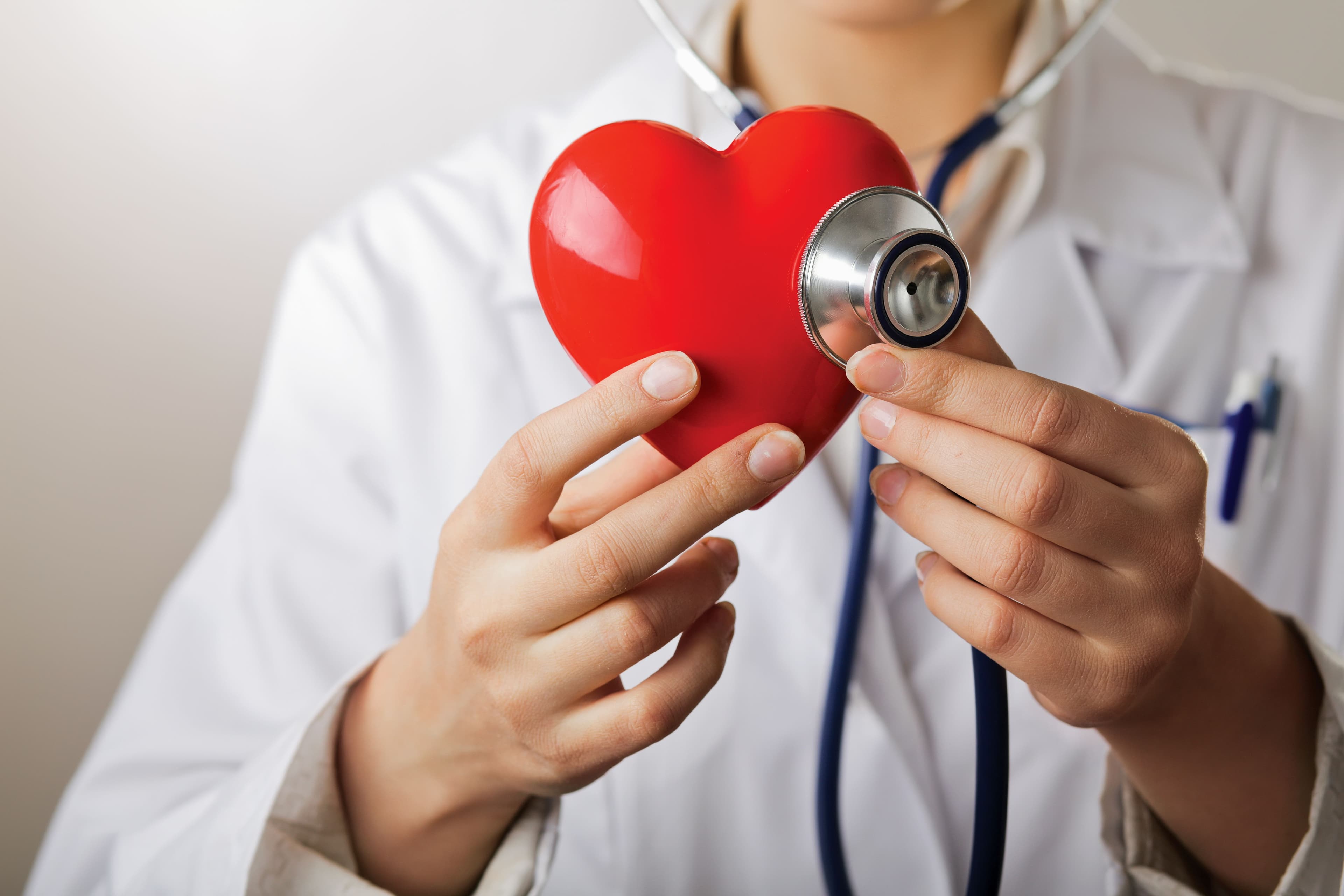 Doctor holding stethoscope to red heart | Image credit: lenets_tan – stock.adobe.com