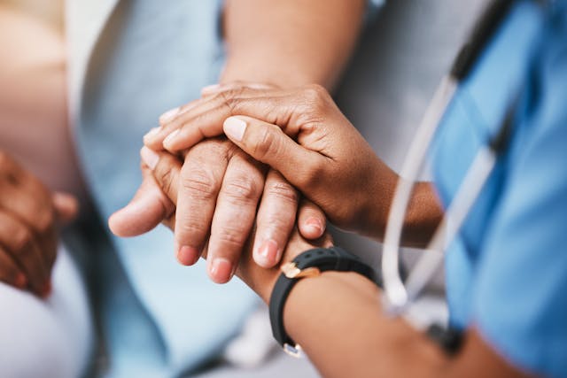 Physician holds hand of patient | Image Credit: © C Davids/peopleimages.com - stock.adobe.com