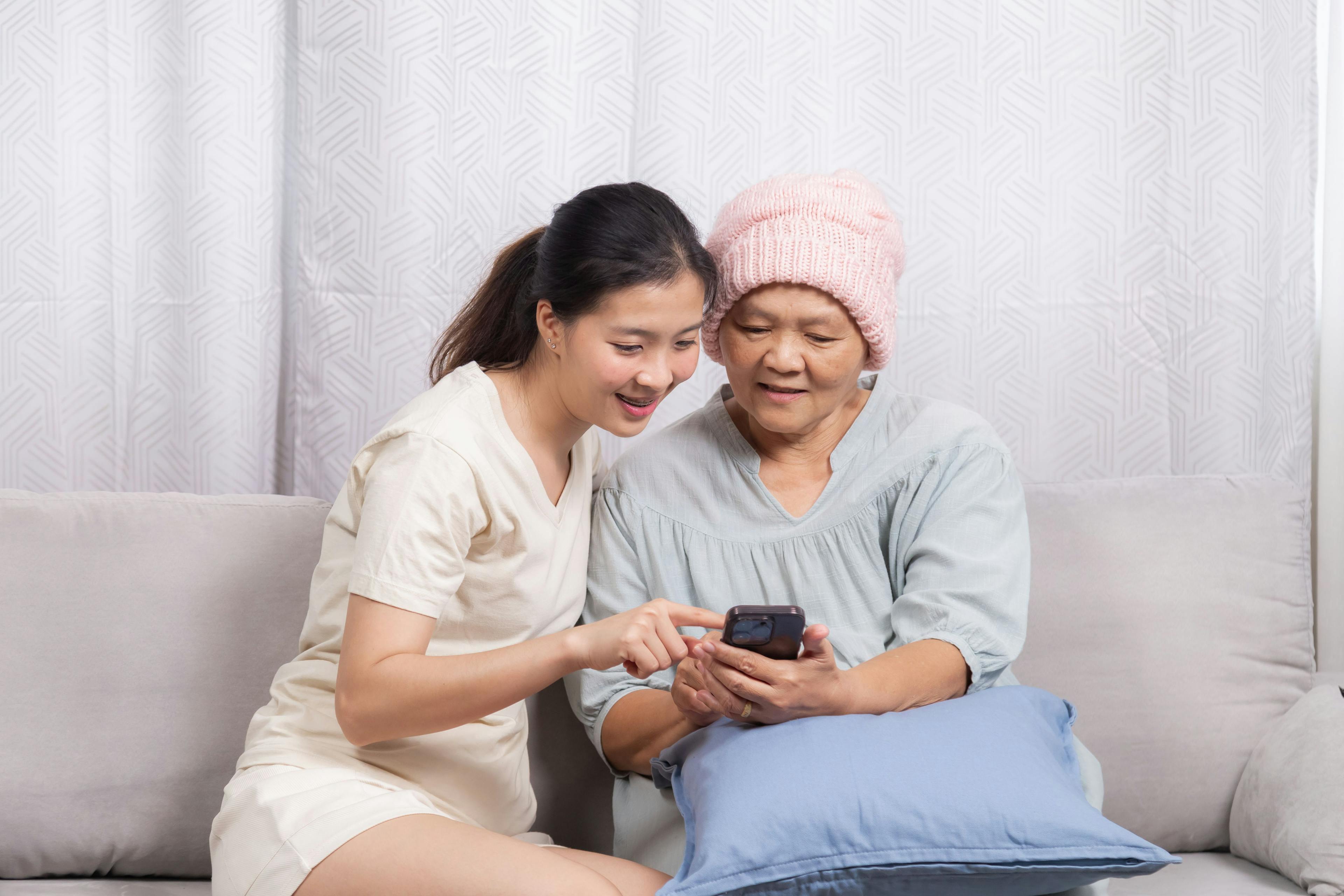 Patient with breast cancer using mobile app to track symptoms. | Image Credit: Rakchanok - stock.adobe.com