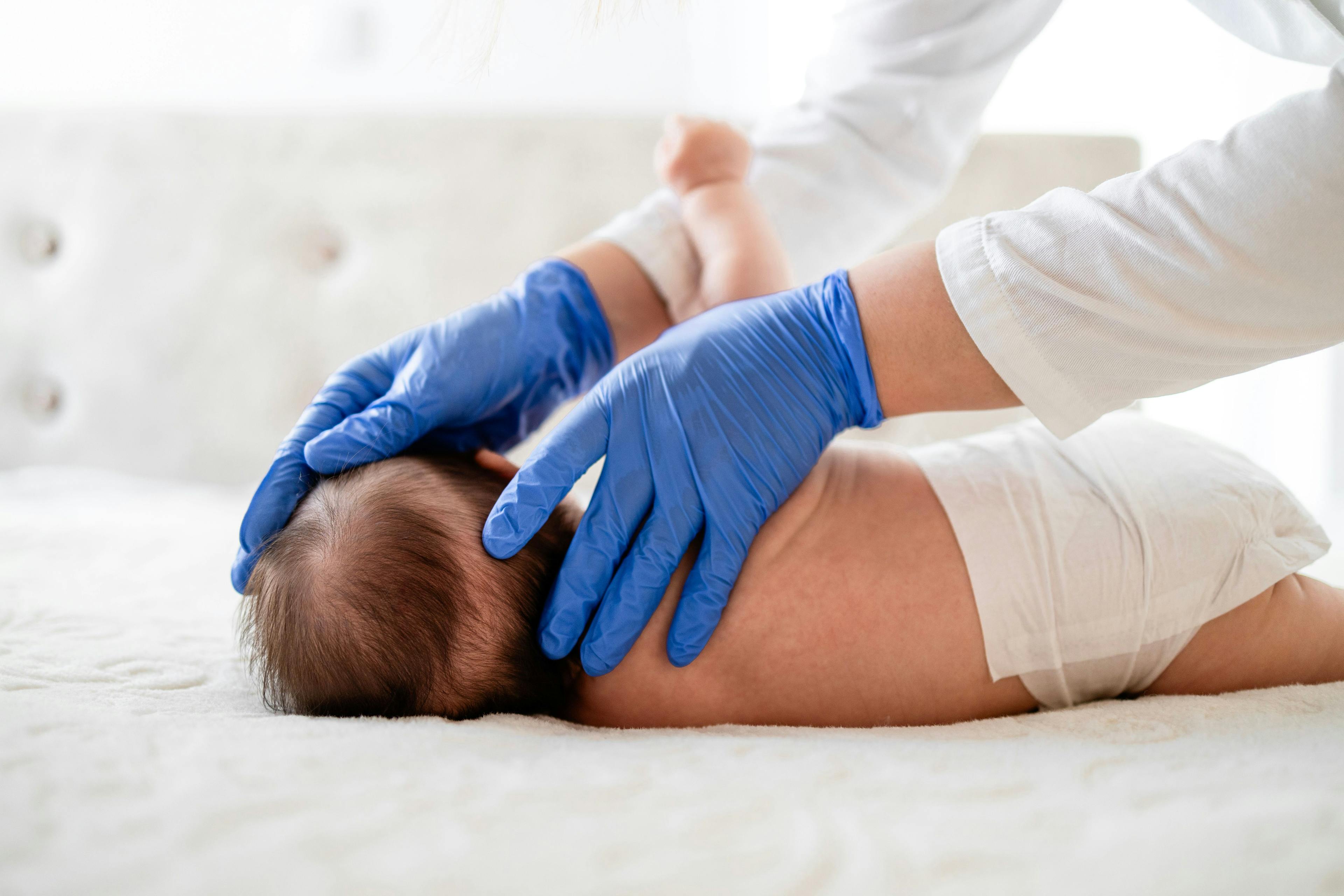 Doctor examines scalp of baby for hair loss. | Image Credit:  littlewolf1989 - stock.adobe.com