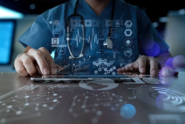 Doctor on a tablet with images related to health data projected above | Image credit: everythingpossible - stock.adobe.com