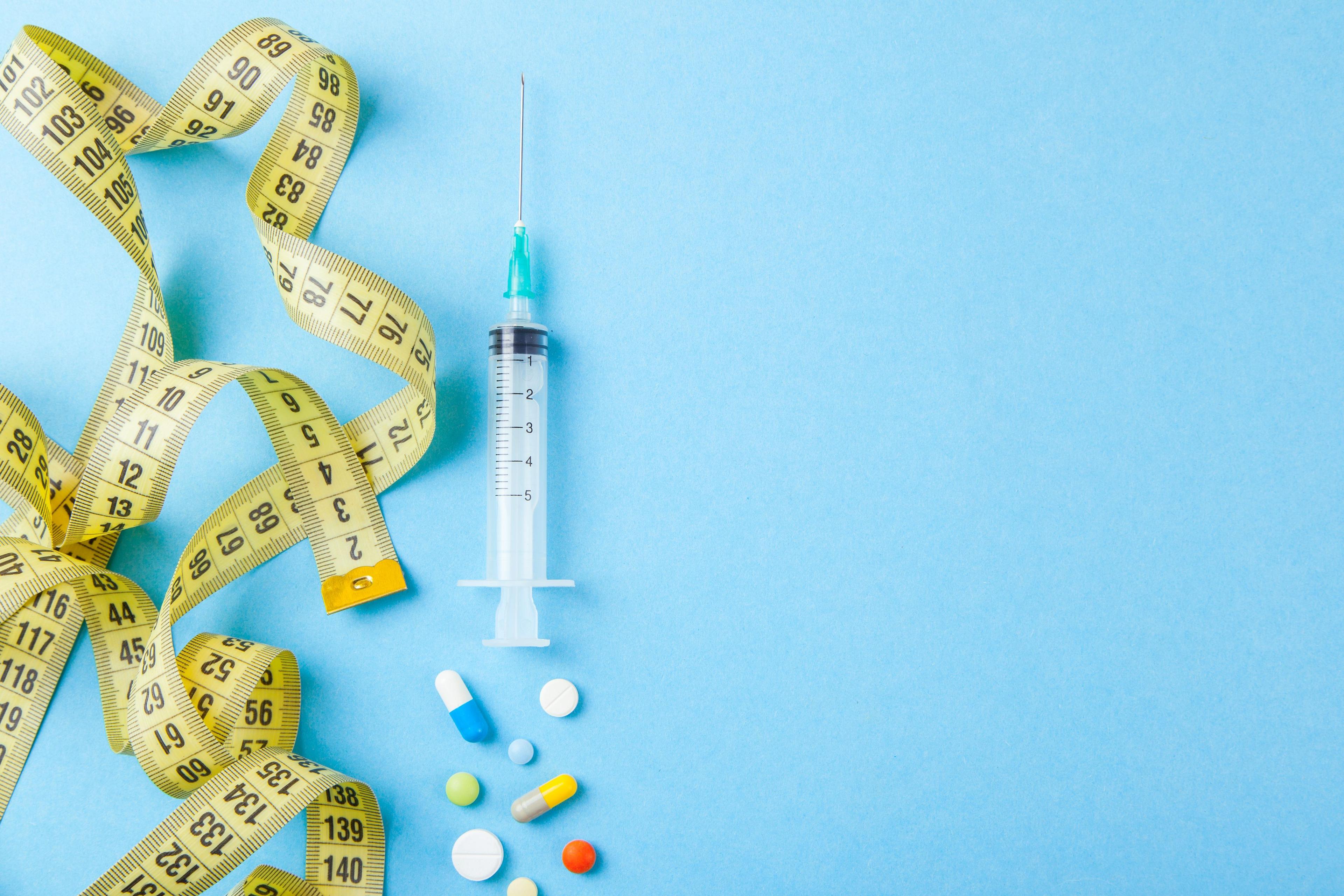 Syringe, pills, and measuring tape | Image credit: adragan – stock.adobe.com