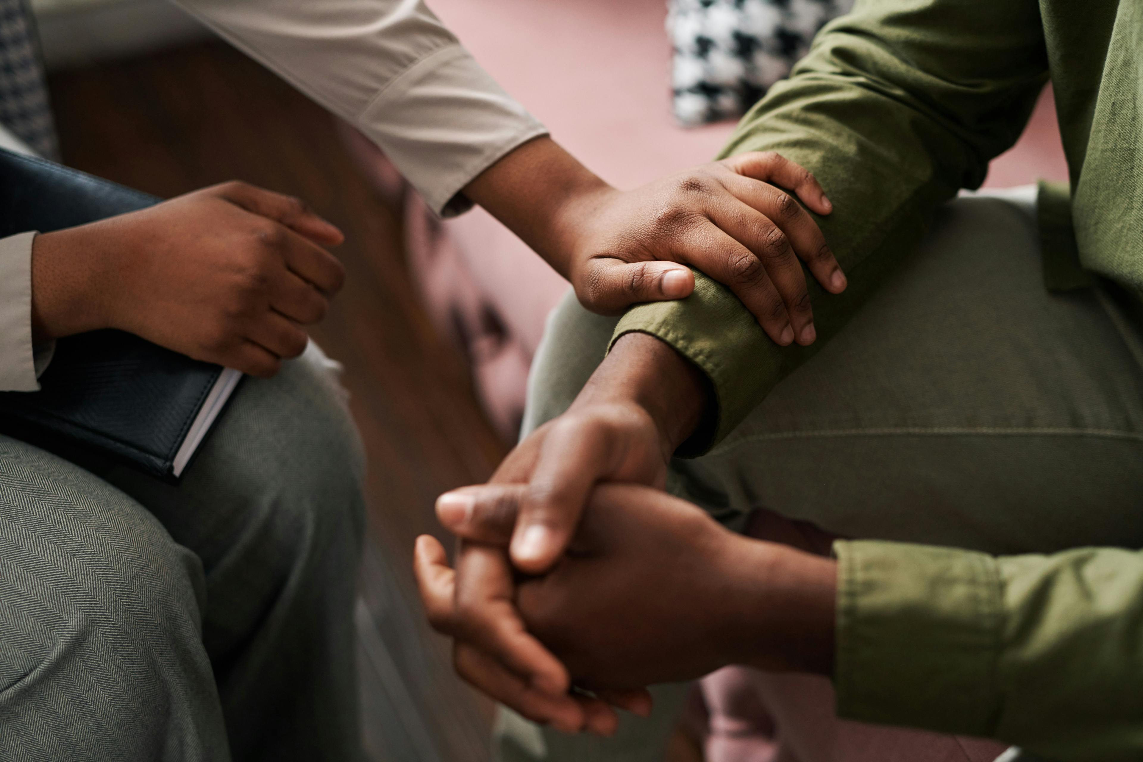 Psychologist holding arm of patient in support | Image credit: pressmaster - stock.adobe.com