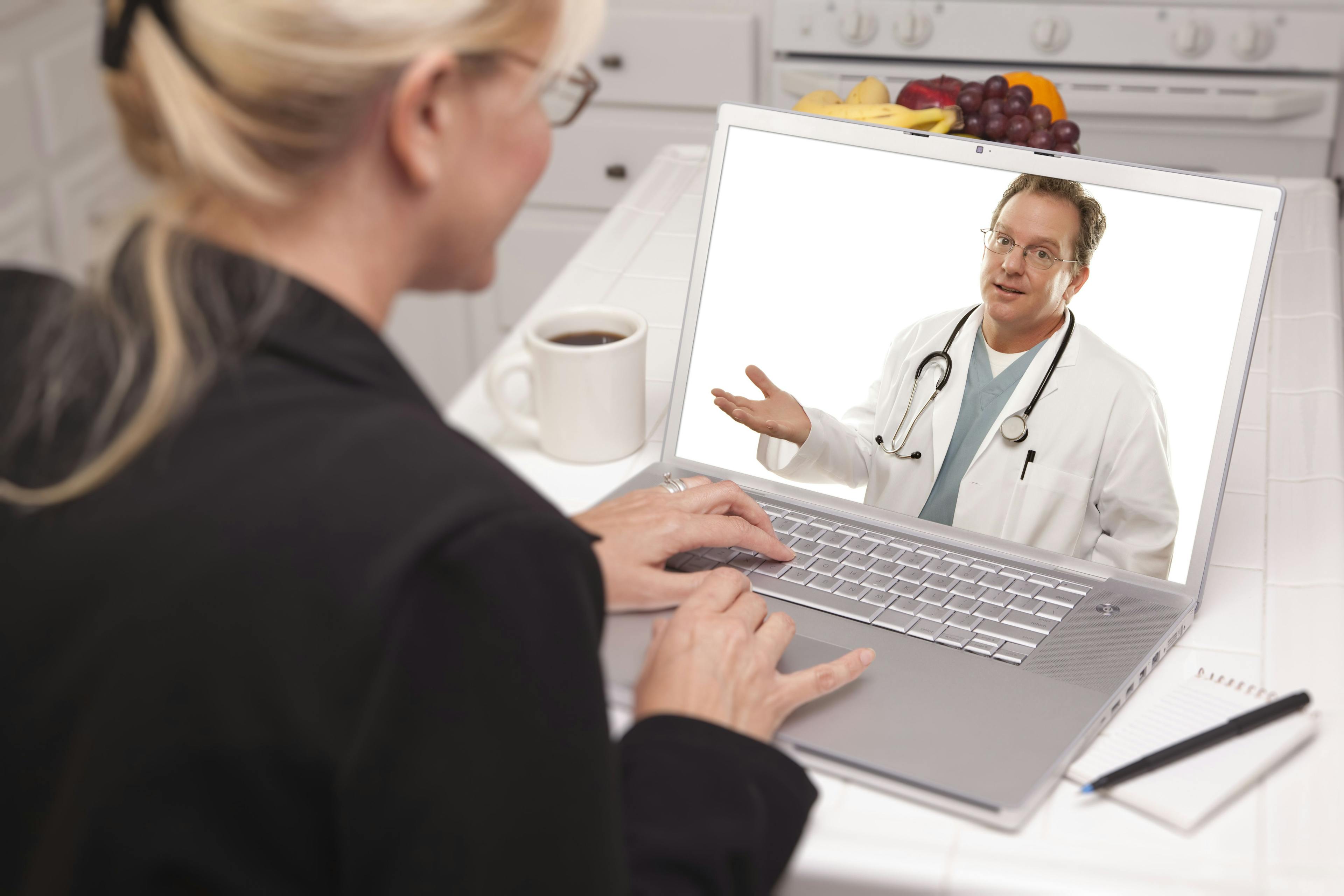 Patient in telehealth session on a computer.