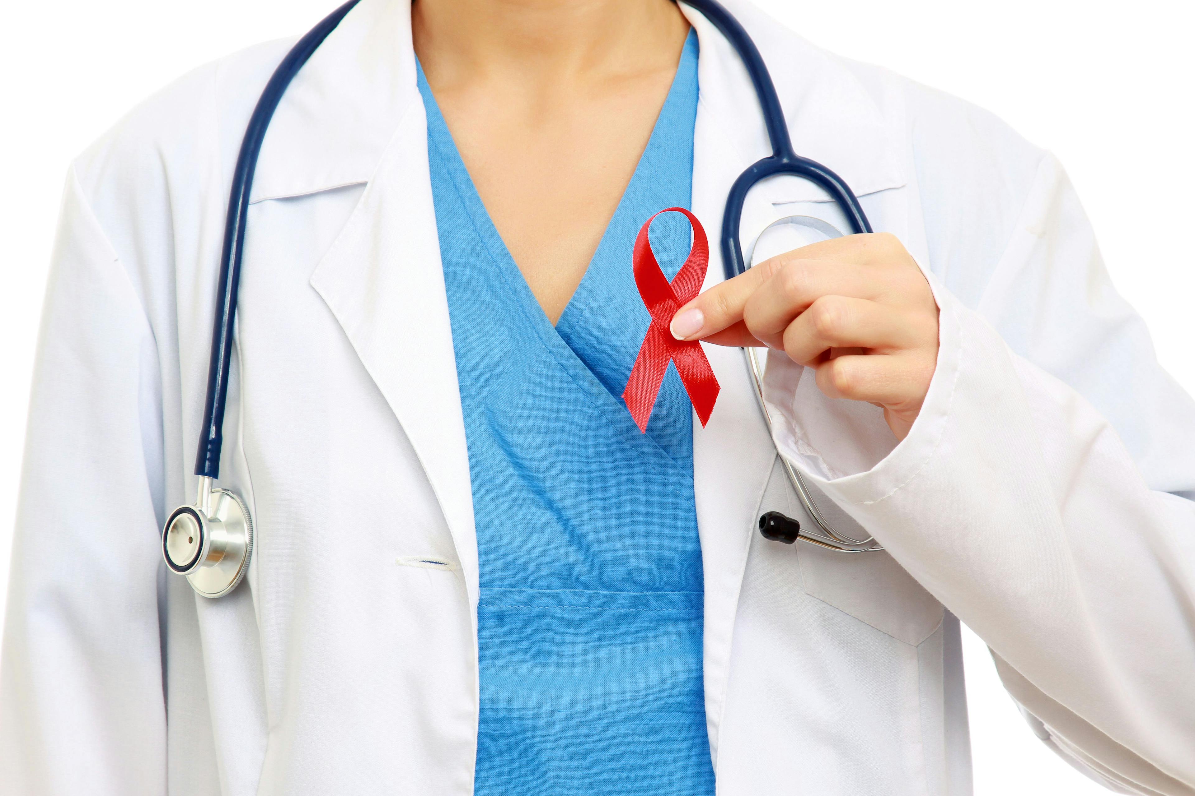 Physician holding an HIV ribbon