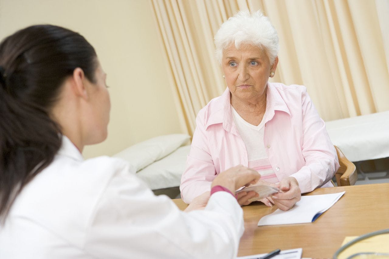 Older Patient Consulting With Doctor