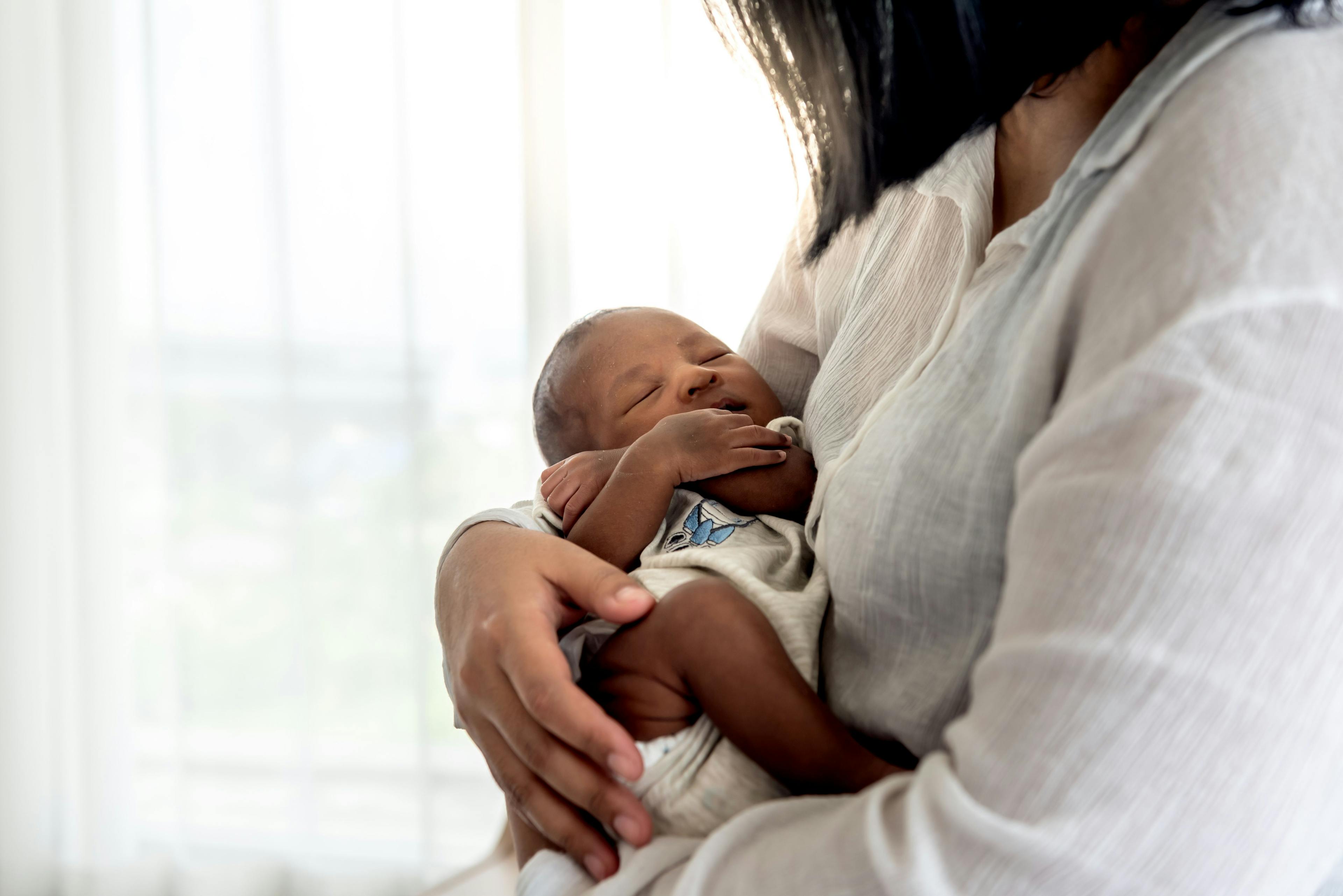 mother holding sleeping infant | Image Credit: Anatta_Tan - stock.adobe.com