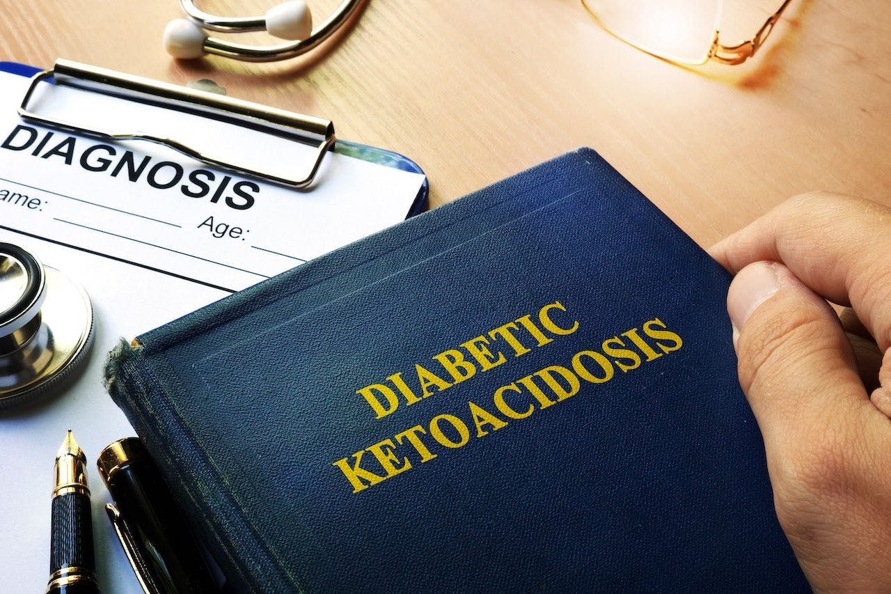 Doctor holding book about diabetic ketoacidosis | Image credit: Vitalii Vodolazskyi.jpeg
