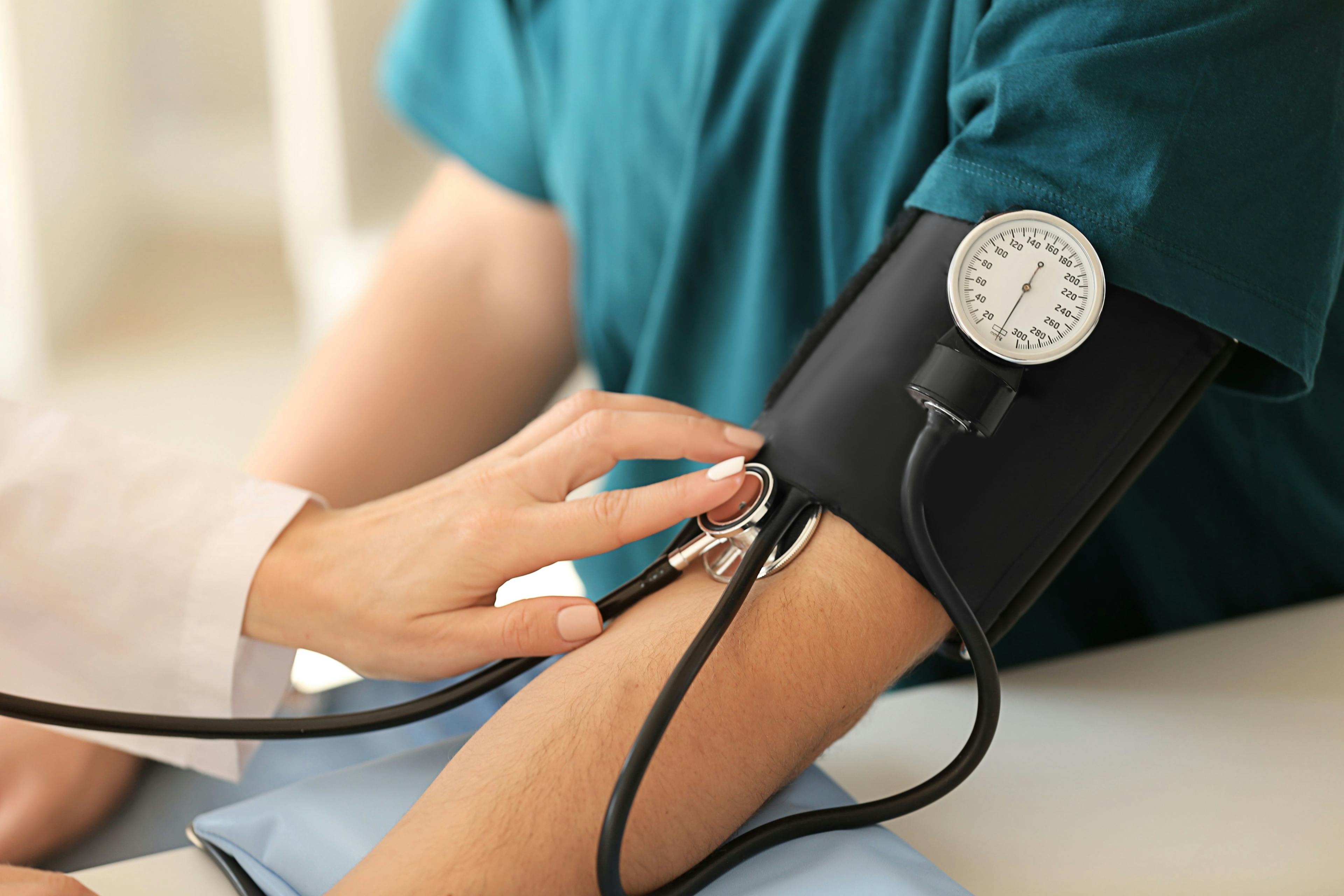 Doctor taking patient's blood pressure | Image credit: Pixel-Shot - stock.adobe.com